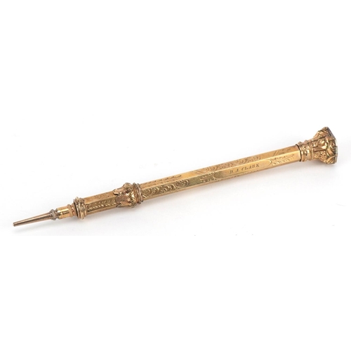 342 - Victorian yellow metal propelling pencil with orange shield shaped stone end, 12cm in length