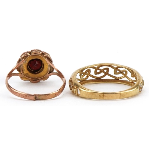 2143 - Two 9ct gold rings comprising a garnet cluster and two tone open work example, sizes O and R, total ... 