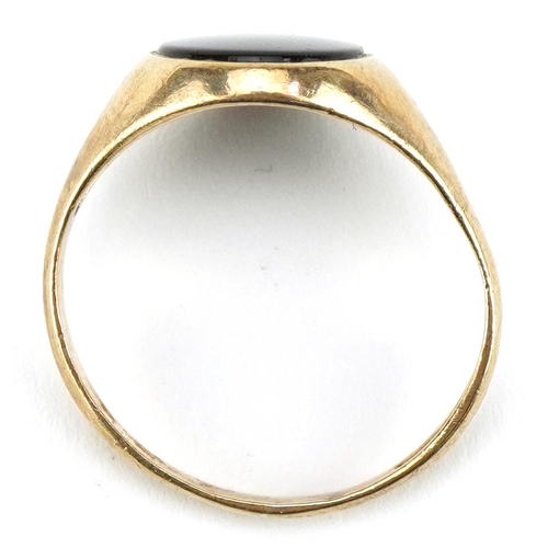 2120 - 9ct gold black onyx signet ring, the black onyx approximately 11.5mm x 9.7mm, size R, 2.5g