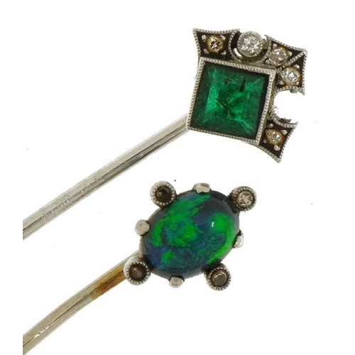 2113 - Two antique and later white metal stickpins housed in a leather box, comprising cabochon opal, white... 