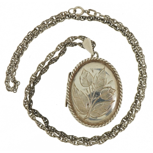 2380 - Oval silver locket with rope twist decoration and floral engraving on a silver necklace, 4.5cm high ... 