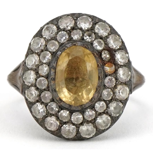 2082 - Georgian style unmarked white metal citrine and paste cluster ring, the citrine approximately 8.6mm ... 