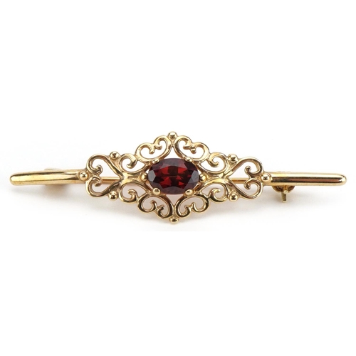 2195 - 9ct gold openwork garnet bar brooch, 4.4cm wide, 2.4g