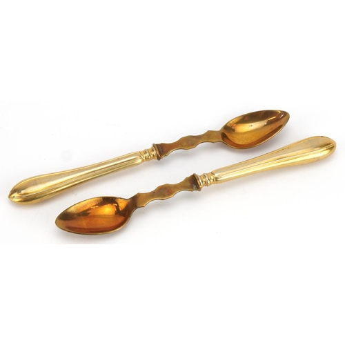 1245 - Set of twelve gilt metal spoons impressed THEO housed in a fitted case, 16.5cm in length