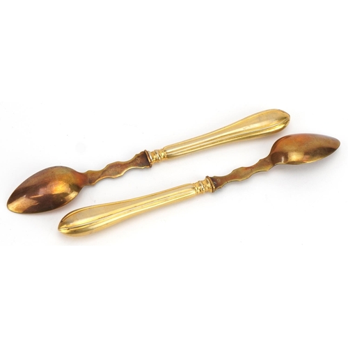 1245 - Set of twelve gilt metal spoons impressed THEO housed in a fitted case, 16.5cm in length