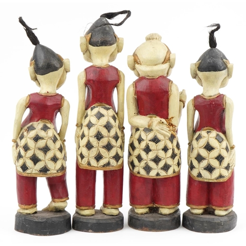 510 - Four Thai hand painted carved wood figures, the largest 52cm high