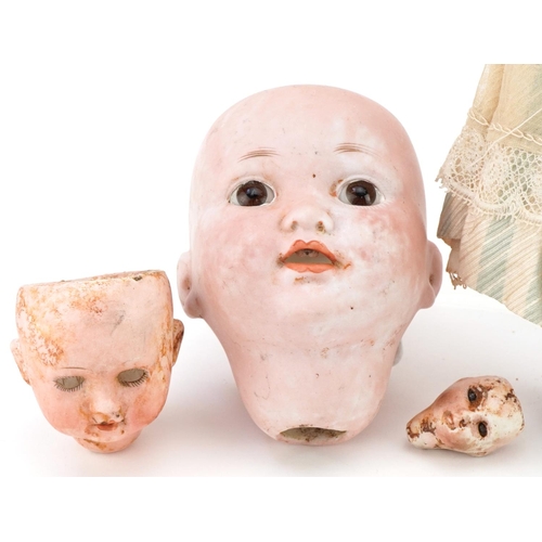 1396 - Antique porcelain costume doll and three German bisque doll's heads including Armand Marseille, the ... 