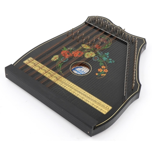 416 - German Jubeltone ebonised zither decorated with flowers, 56cm high