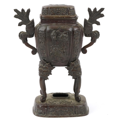 650 - Japanese patinated bronze four footed koro and cover with twin handles on stand cast with panels of ... 