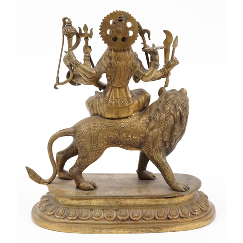 197 - Indian patinated bronze figure of Durga on lion back, 36cm high