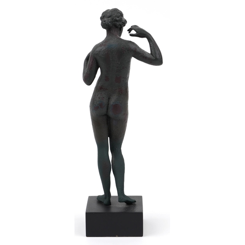 673 - Verdigris bronzed style statuette of Venus raised on a square ebonised base, 28.5cm high