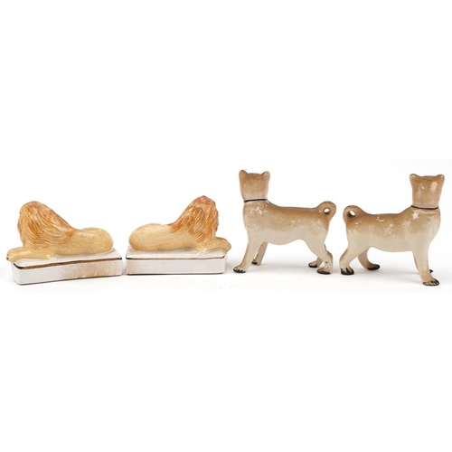 659 - Pair of Staffordshire style dogs and a similar pair of recumbent lions, each 14.5cm wide