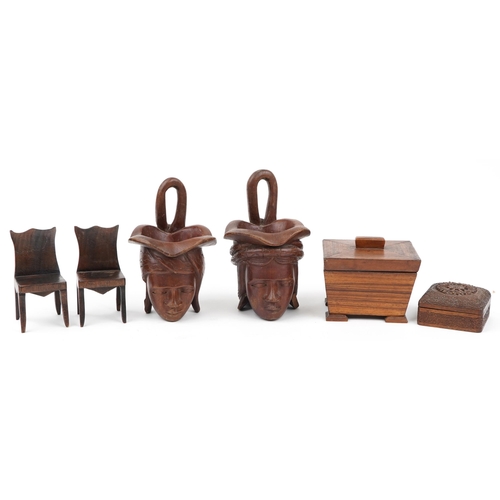 602 - Woodenware including a rosewood casket and a pair of Indian figural cups, the largest 24cm high