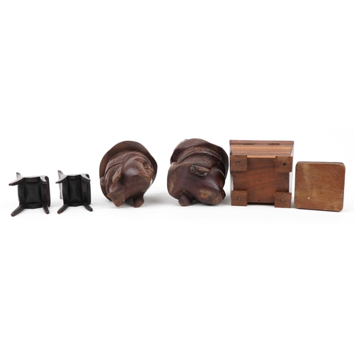 602 - Woodenware including a rosewood casket and a pair of Indian figural cups, the largest 24cm high