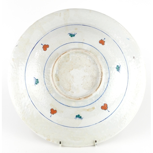 31 - Turkish Ottoman Iznik plate hand painted with a figure and stylised flowers, 32cm in diameter