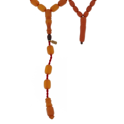 2383 - Two Islamic prayer bead necklaces including a cherry amber coloured example, the largest 47cm in len... 