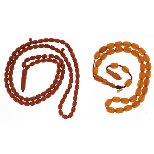 2383 - Two Islamic prayer bead necklaces including a cherry amber coloured example, the largest 47cm in len... 