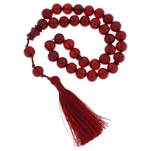 2125 - Cherry amber coloured Islamic prayer bead necklace with tassel, 77.9g