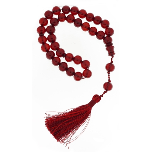 2125 - Cherry amber coloured Islamic prayer bead necklace with tassel, 77.9g