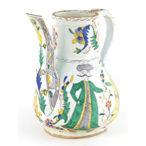 30 - Turkish Ottoman Kutahya pottery water jug hand painted with figures and stylised flowers, 19cm high