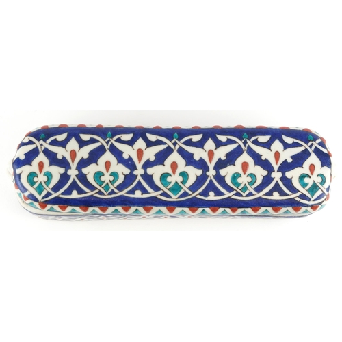 193 - Turkish Iznik pottery pen box and cover, 23.5cm in length