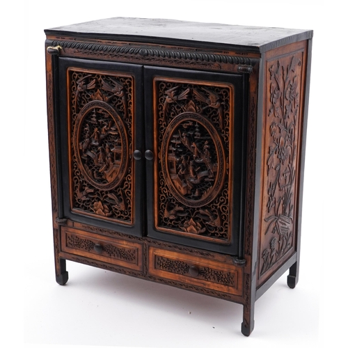 187 - Chinese table cabinet with pair of doors enclosing eight drawers, finely carved and pierced with fig... 