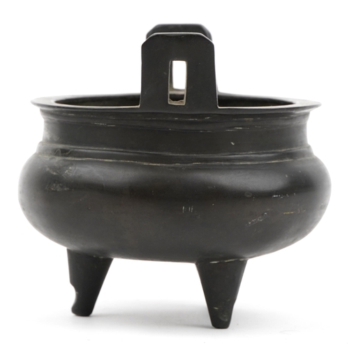 247 - Chinese patinated bronze tripod censer with twin handles, six figure character marks to the base, 12... 