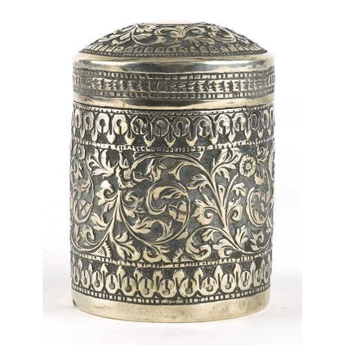 376 - Anglo Indian unmarked silver cylindrical box and cover embossed with flowers and vines, 7.5cm high, ... 