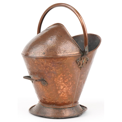 641 - Planished copper helmet shaped scuttle with swing handle, 40cm high excluding the handle