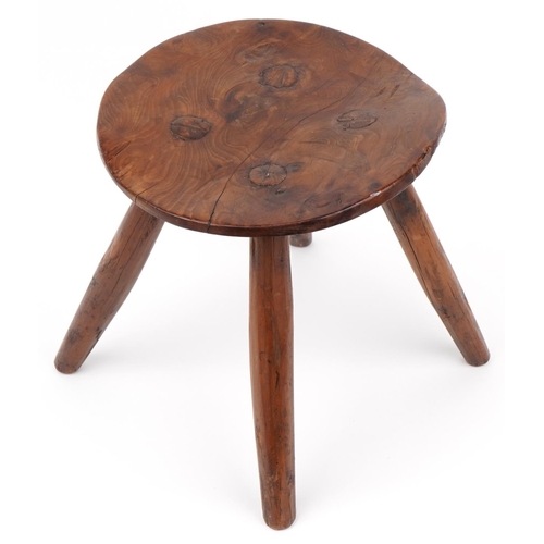 1033 - Farmhouse style yew wood four footed stool, 28cm high x 27.5cm in diameter