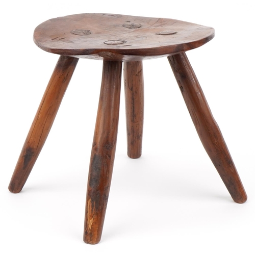 1033 - Farmhouse style yew wood four footed stool, 28cm high x 27.5cm in diameter