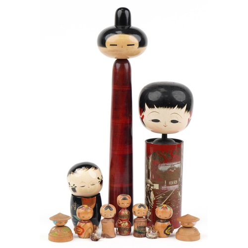 329 - Nine Japanese wooden and lacquered Kokeshi dolls, the largest 48cm high