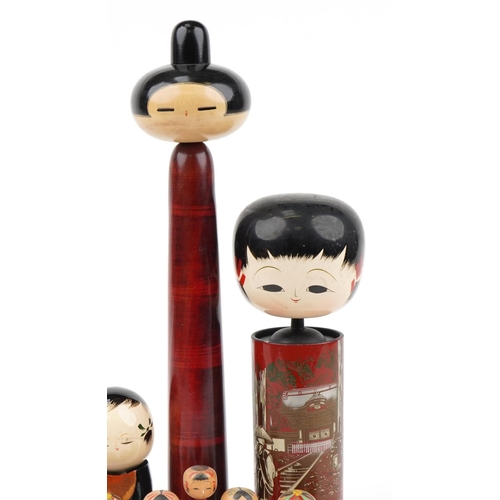 329 - Nine Japanese wooden and lacquered Kokeshi dolls, the largest 48cm high