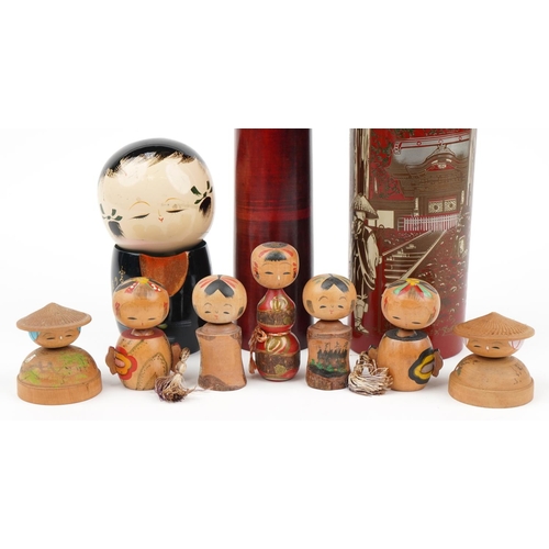 329 - Nine Japanese wooden and lacquered Kokeshi dolls, the largest 48cm high