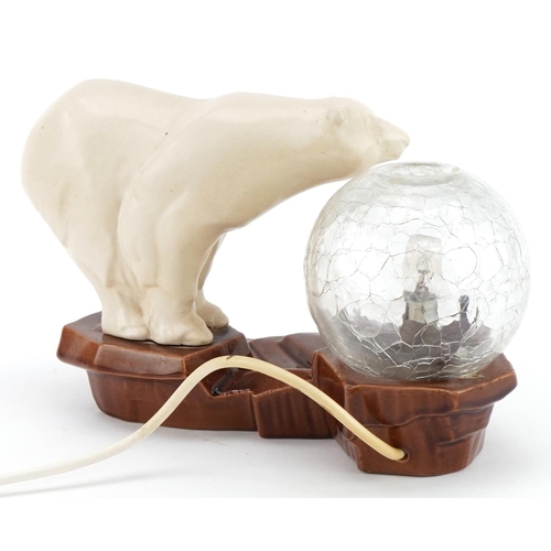203 - Art Deco polar bear design table lamp with globular glass shade, 25cm wide