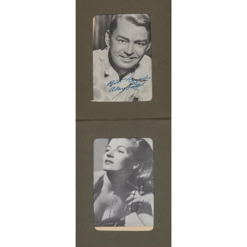 1602 - Collection of film star postcards with facsimile signatures arranged in an album including Marilyn M... 