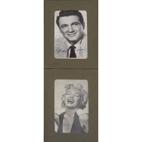 1602 - Collection of film star postcards with facsimile signatures arranged in an album including Marilyn M... 