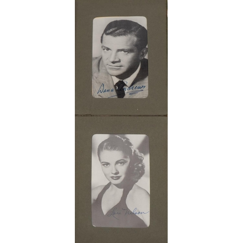 1602 - Collection of film star postcards with facsimile signatures arranged in an album including Marilyn M... 