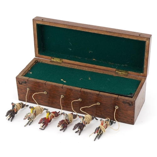 1472 - Oak cased Ascot new horseracing game with hand painted lead jockeys on horseback, 25cm wide