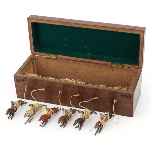 1472 - Oak cased Ascot new horseracing game with hand painted lead jockeys on horseback, 25cm wide