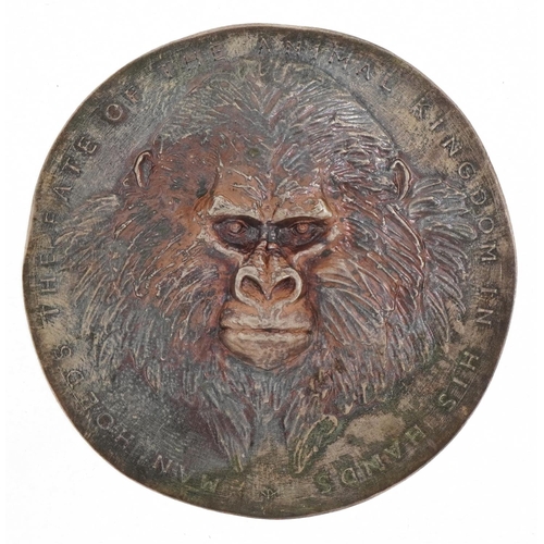 1597 - Unmarked silver wildlife medallion cast with whales and a gorilla, Man hold's the state of animal ki... 