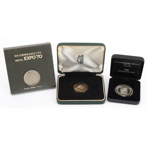 1598 - Three silver medallions with fitted cases comprising Rugby World Cup Supporters medal, Pan World Exp... 