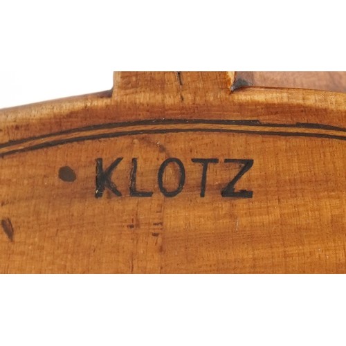 409 - Old wooden violin with bow and protective case, the violin back impressed Klotz and 14 inches in len... 