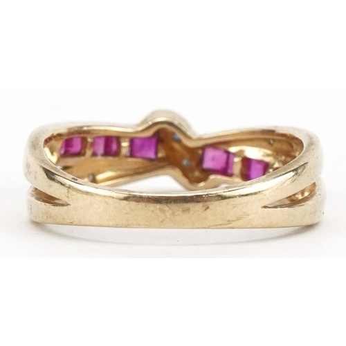 2029 - 9ct gold ruby and diamond crossover ring, size O/P, 2.5g