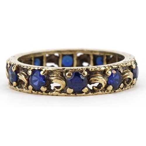 2178 - Unmarked gold sapphire eternity ring with pierced decoration, tests as 9ct gold, size M, 3.0g