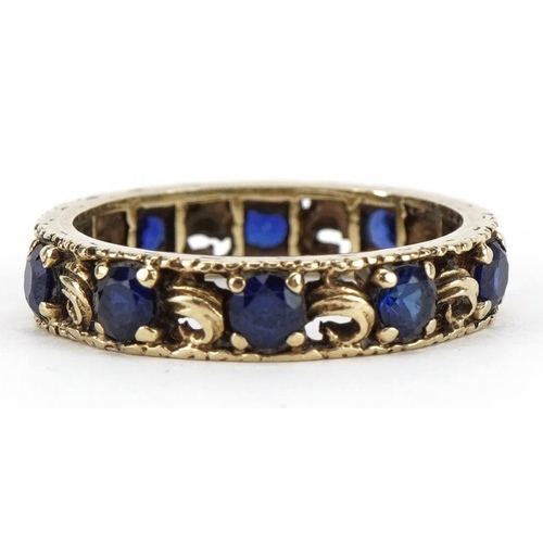 2178 - Unmarked gold sapphire eternity ring with pierced decoration, tests as 9ct gold, size M, 3.0g