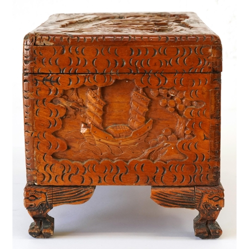 1034 - Chinese camphor wood table top chest carved with junks, 25cm H x 40cm W x 23cm D