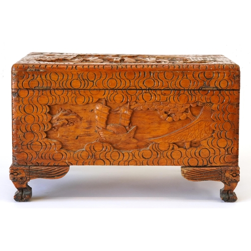 1034 - Chinese camphor wood table top chest carved with junks, 25cm H x 40cm W x 23cm D