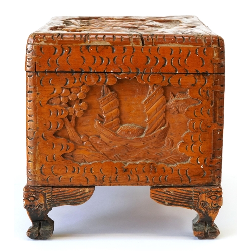 1034 - Chinese camphor wood table top chest carved with junks, 25cm H x 40cm W x 23cm D