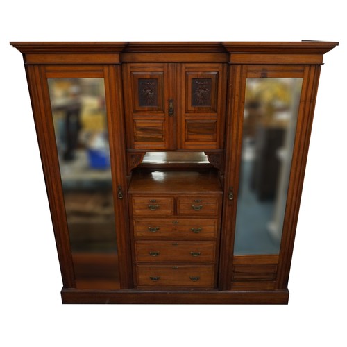 1038 - Edwardian satinwood compactum wardrobe with two bevelled glass mirrored doors, two central cupboard ... 